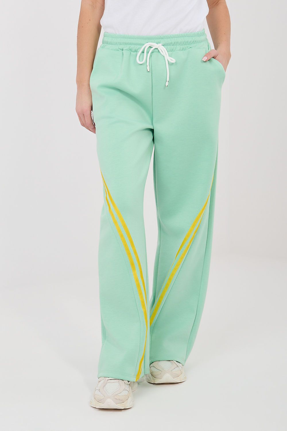 Mint green wide-leg tracksuit trousers with drawstring waist and yellow side stripe.