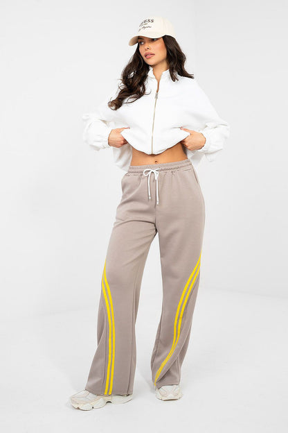 Gray track pants with drawstring waist and yellow side stripe detailing