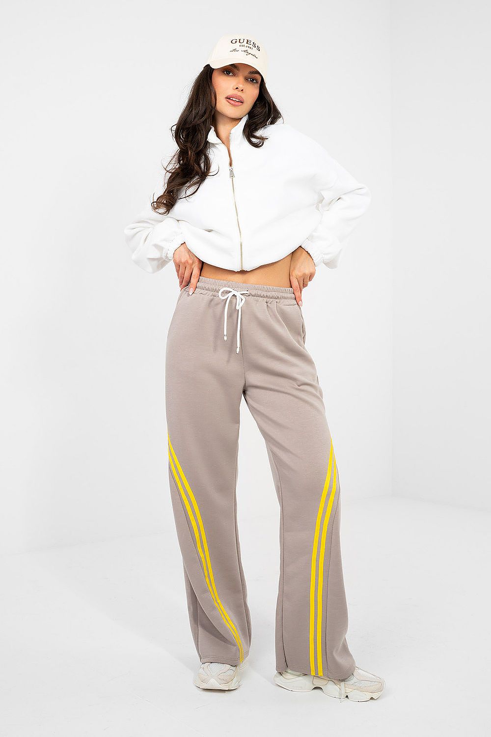 Gray track pants with drawstring waist and yellow side stripe panels