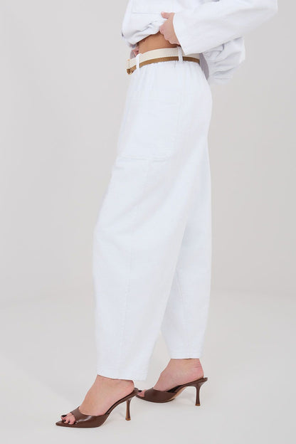 White corduroy trousers with high waist, belt loops, and side pockets
