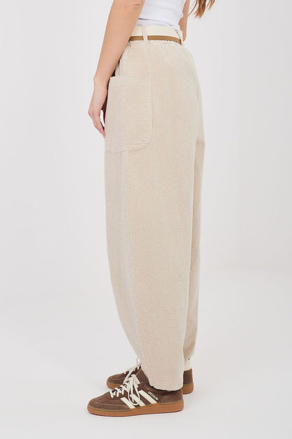 Beige corduroy trousers with large side pockets and belt loops, relaxed fit