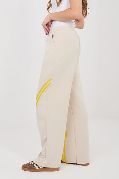 Tracksuit trousers, light beige wide legs with yellow side stripe, drawstring elastic waist