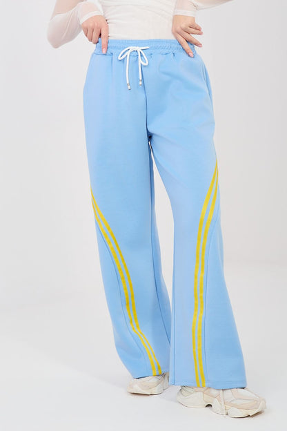 Light blue track pants with drawstring waist and yellow side stripe