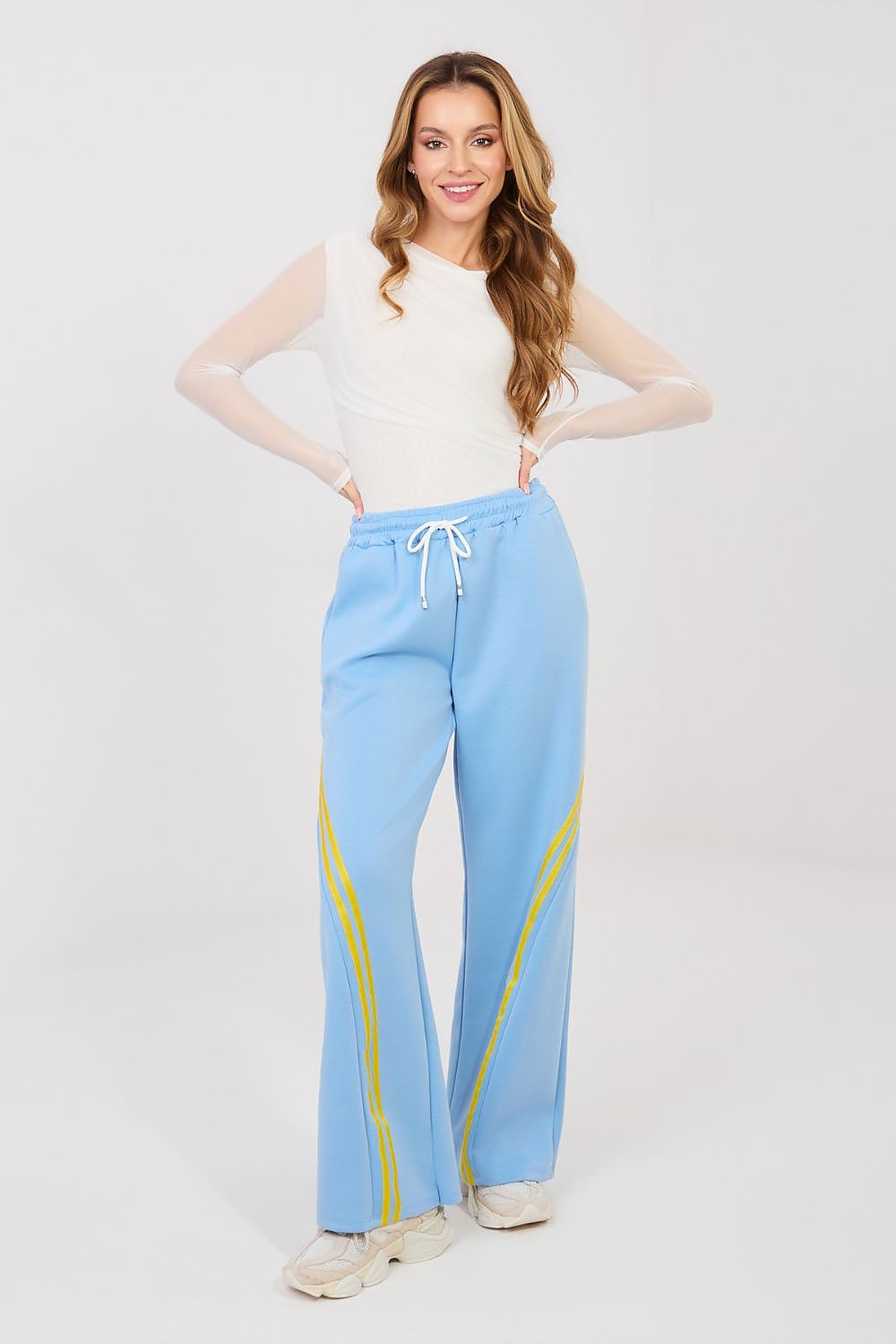 Light blue track pants with drawstring waist and yellow side stripes