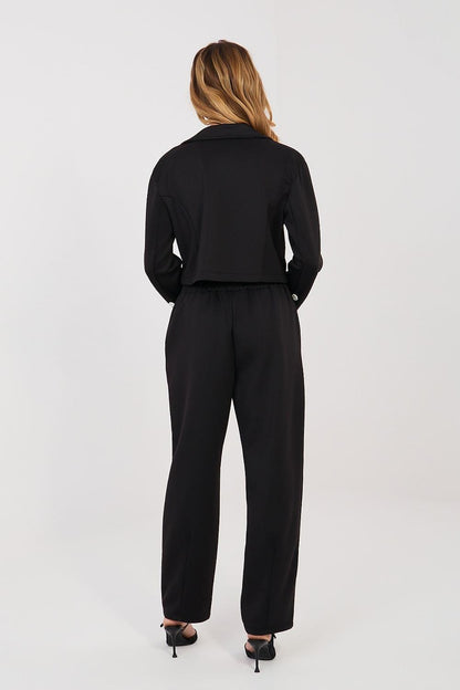 Black two-piece pantsuit set with long-sleeve jacket and tapered trousers, back view