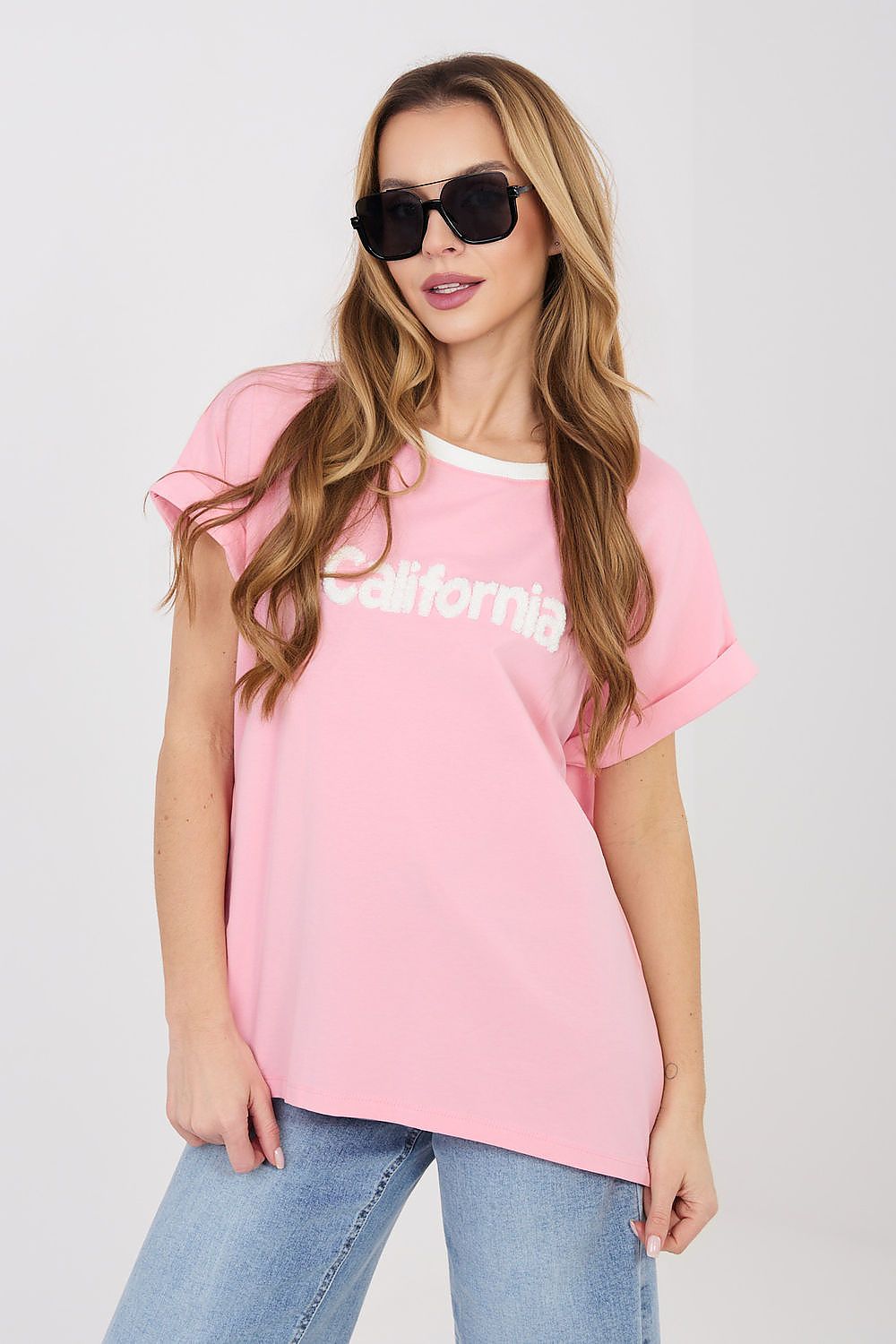 Pink blouse with short sleeves, crew neck, and 'California' graphic on front