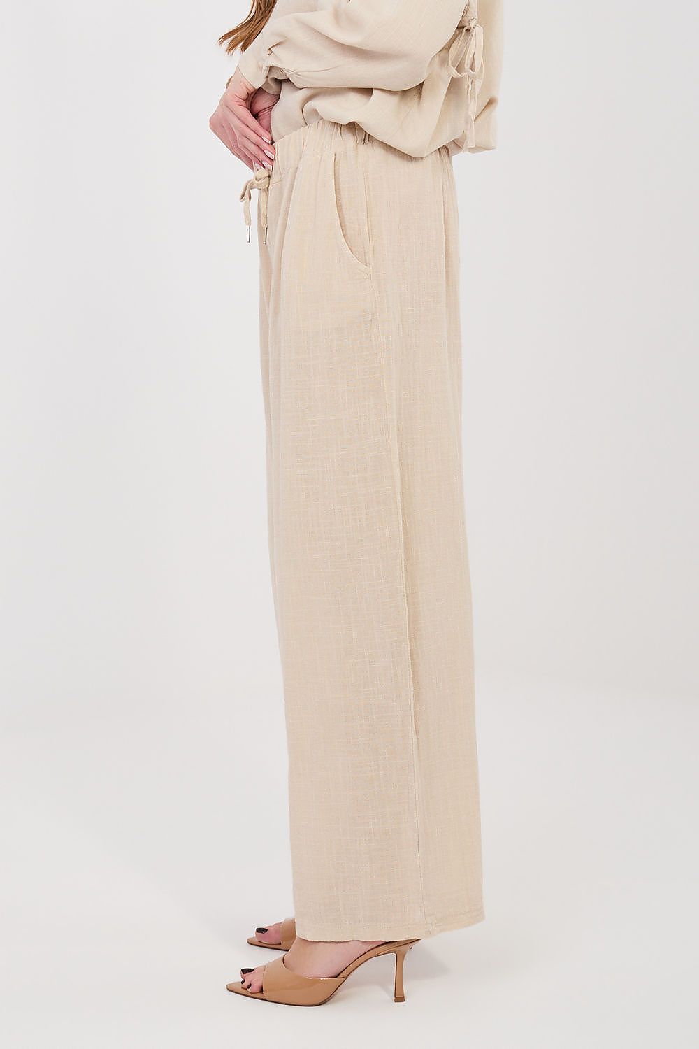 Women’s beige linen-look drawstring wide-leg trousers, side view with high-rise waistband
