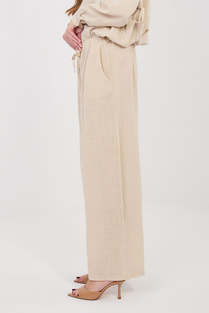 Women’s beige linen-look drawstring wide-leg trousers, side view with high-rise waistband