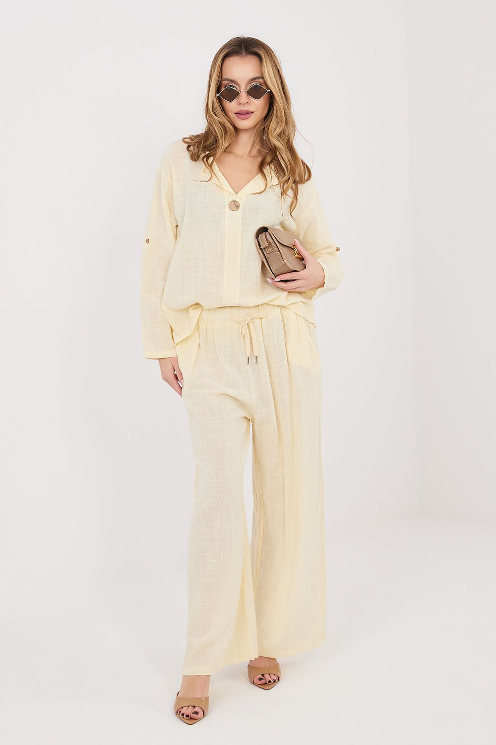 Women’s beige trousers with drawstring waist, front pockets, and wide hems