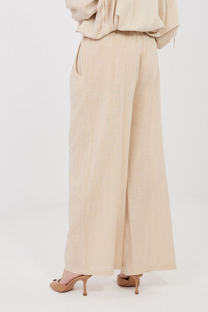 Women’s beige linen-look drawstring wide-leg trousers, close side view of drape