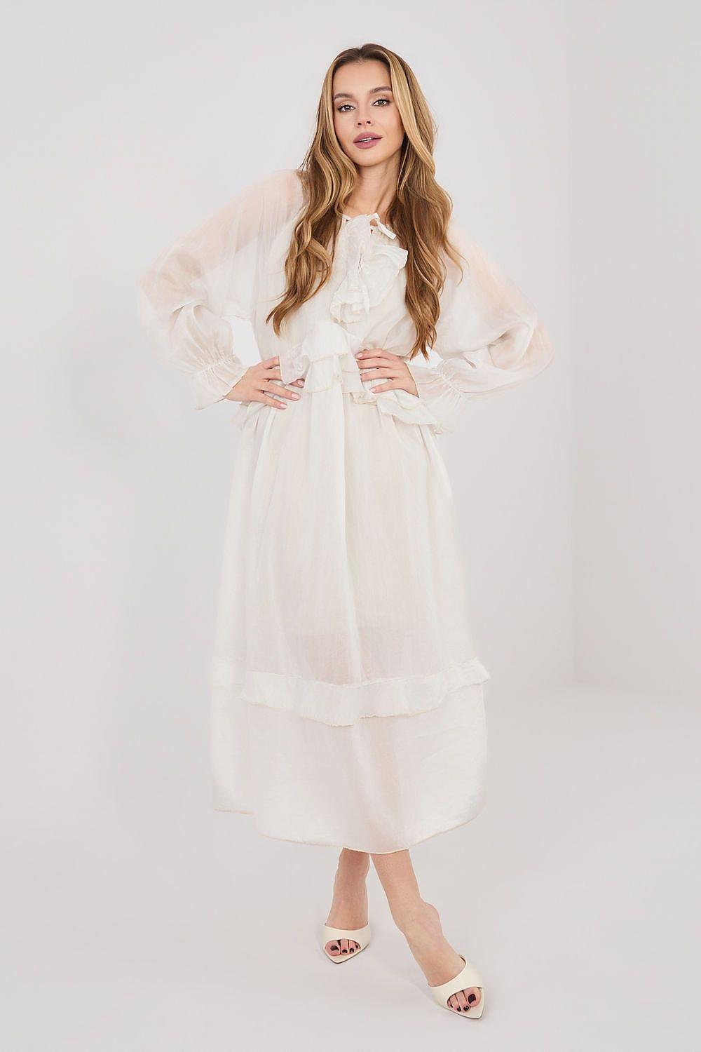 White daydress with long puff sleeves, tie neckline, and tiered ruffle skirt