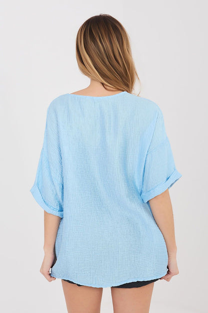 Light blue short-sleeve button shirt, back view with V-shaped yoke