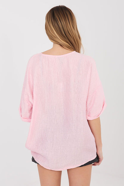 Pink short-sleeve button shirt, back view with loose yoke