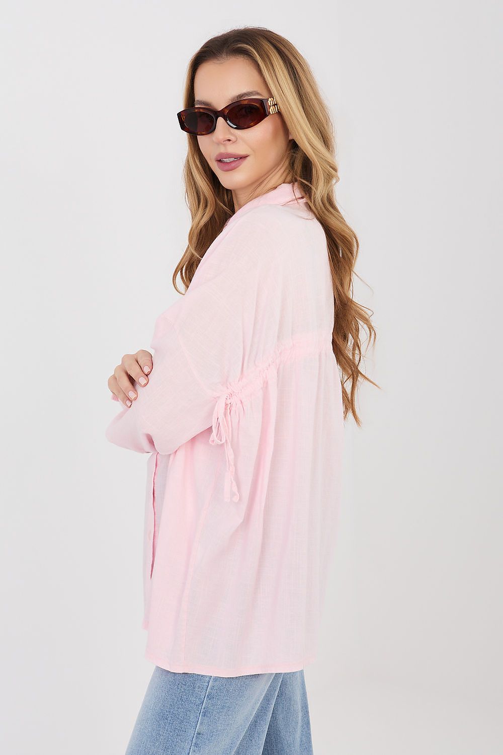Pink long-sleeve shirt with pointed collar, button placket, and tied cuff detail