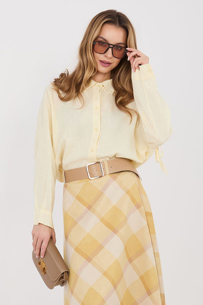 Light yellow long-sleeve button-front shirt with pointed collar and tied sleeve details
