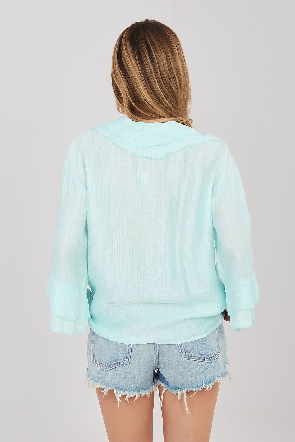 Light blue long-sleeve ruffle-back shirt with hooded collar and button placket
