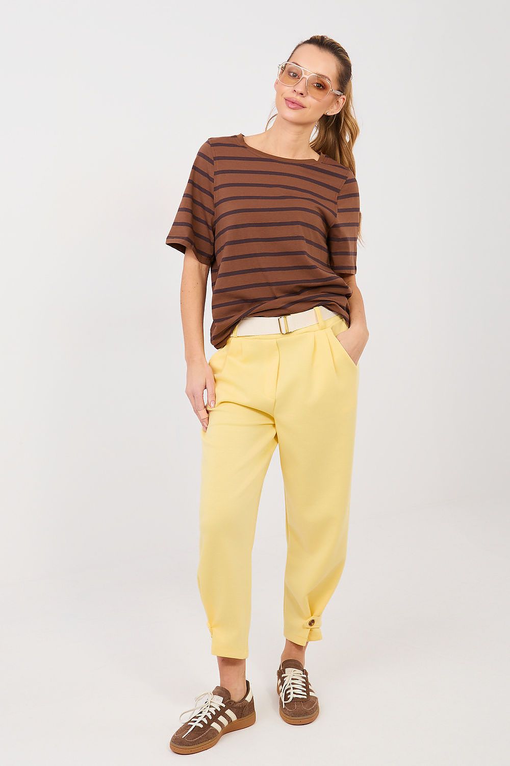 Yellow track pants with elastic waist and ankle cuffs, drawstring tie