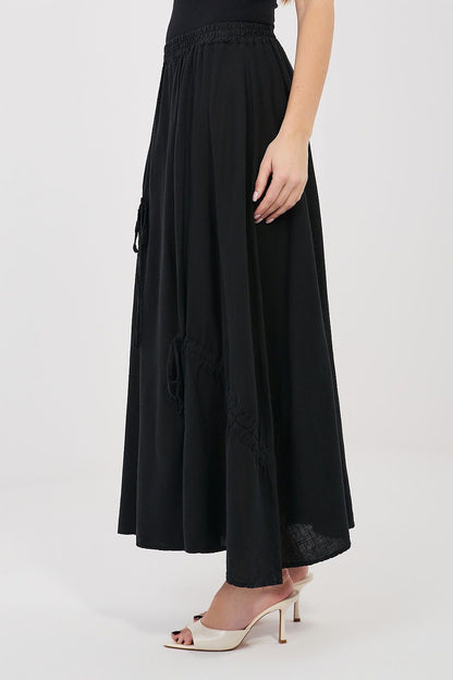 Black long skirt with elastic waistband and drawstring ties at the sides