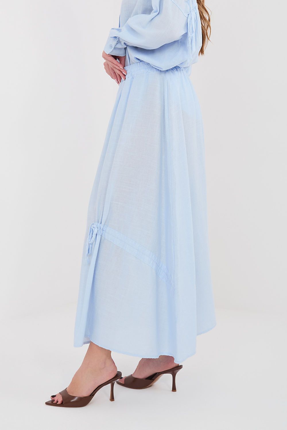 Light blue long skirt with elastic waist and side drawstring ties, midi length