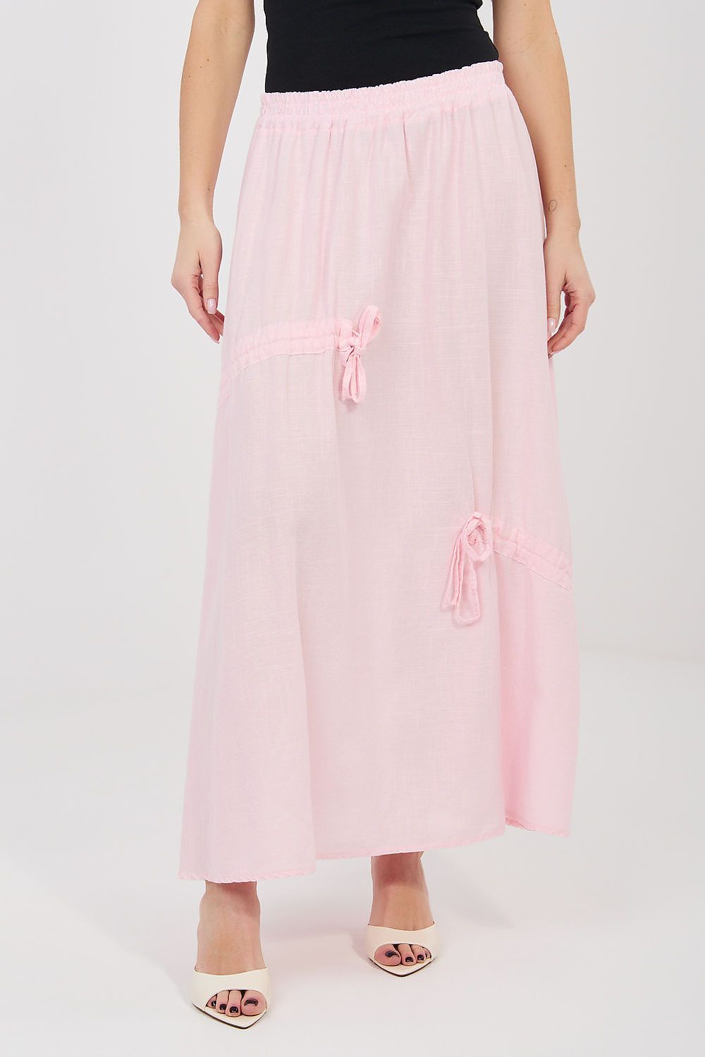 Pink long skirt with elastic waistband, sheer look, and bow-tie details