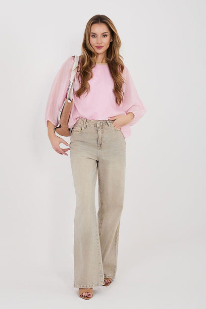 Pink blouse with rounded neckline, billowy sleeves, and loose fit with jeans