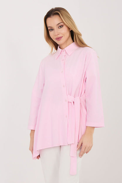 Light pink long sleeve shirt with button front and tied waist, three-quarter sleeves