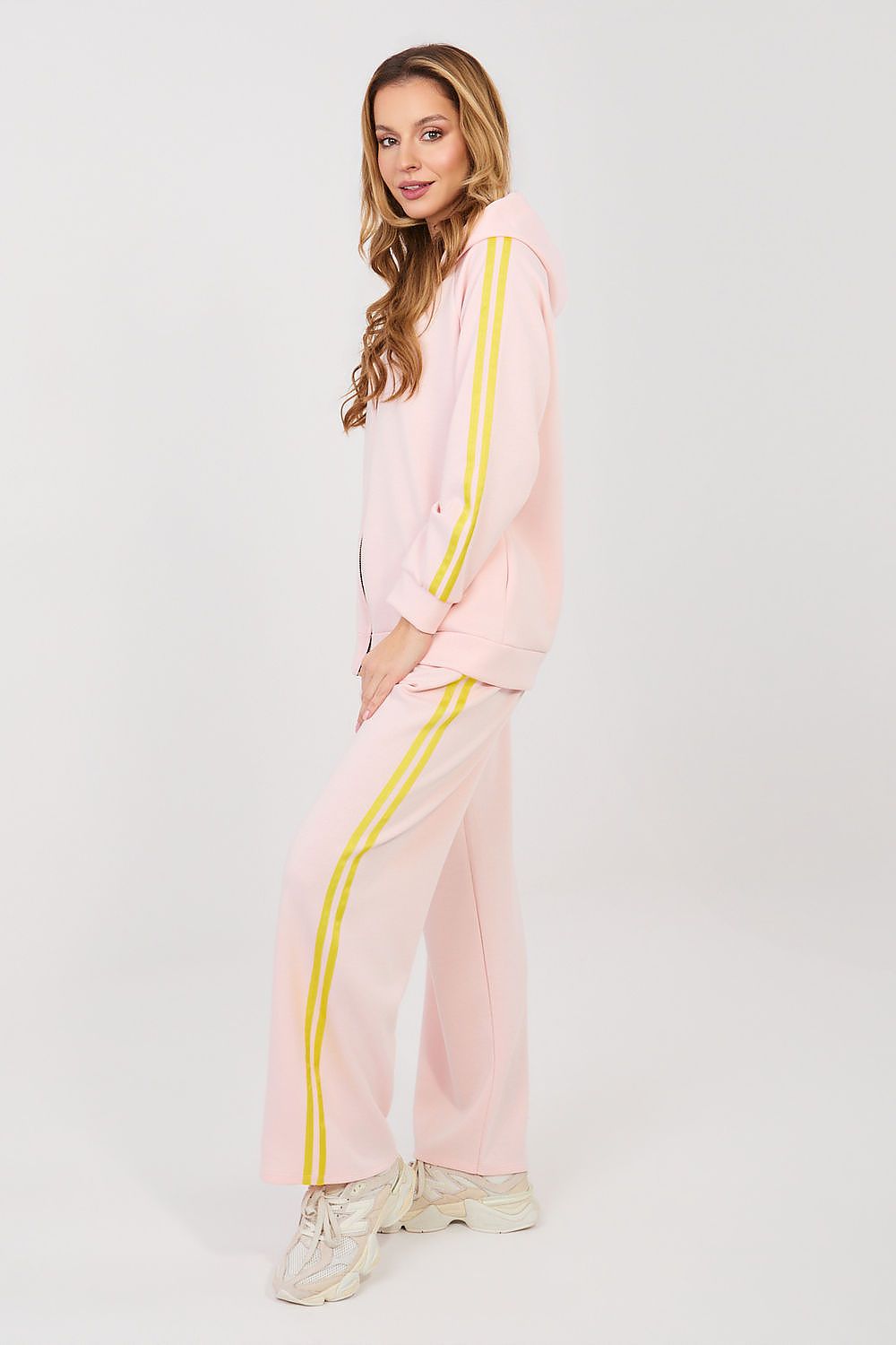 Pink zip-front tracksuit set with yellow side stripe, matching wide-leg pants