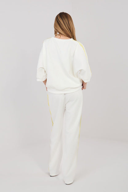 Cream lounge set with yellow stripe accents, relaxed top and wide-leg pants
