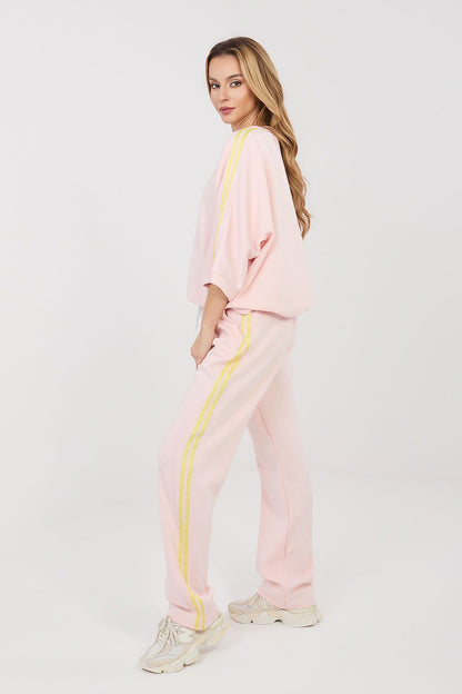 Pink two-piece tracksuit set with yellow side stripe detailing and relaxed jogger pants