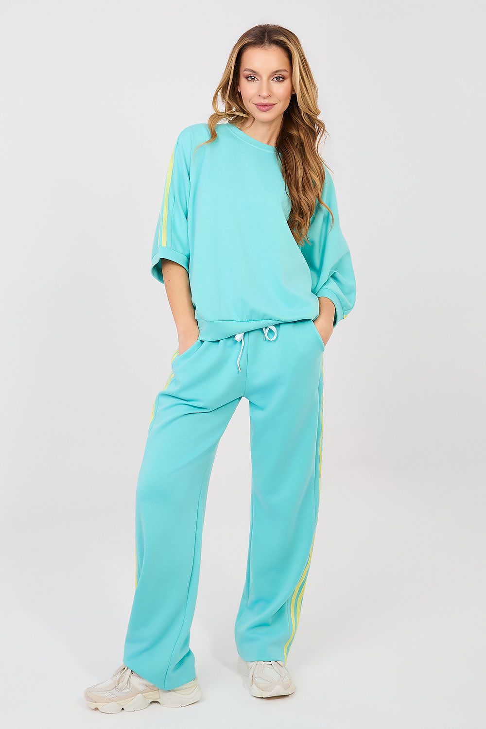 Turquoise two-piece lounge set with drawstring waist jogger pants and matching sweatshirt
