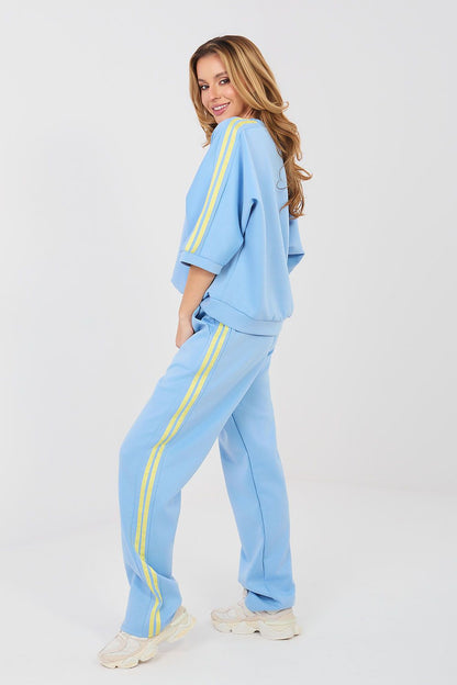 Light blue tracksuit set with crew sweatshirt and joggers, yellow stripe accents on sleeves and legs