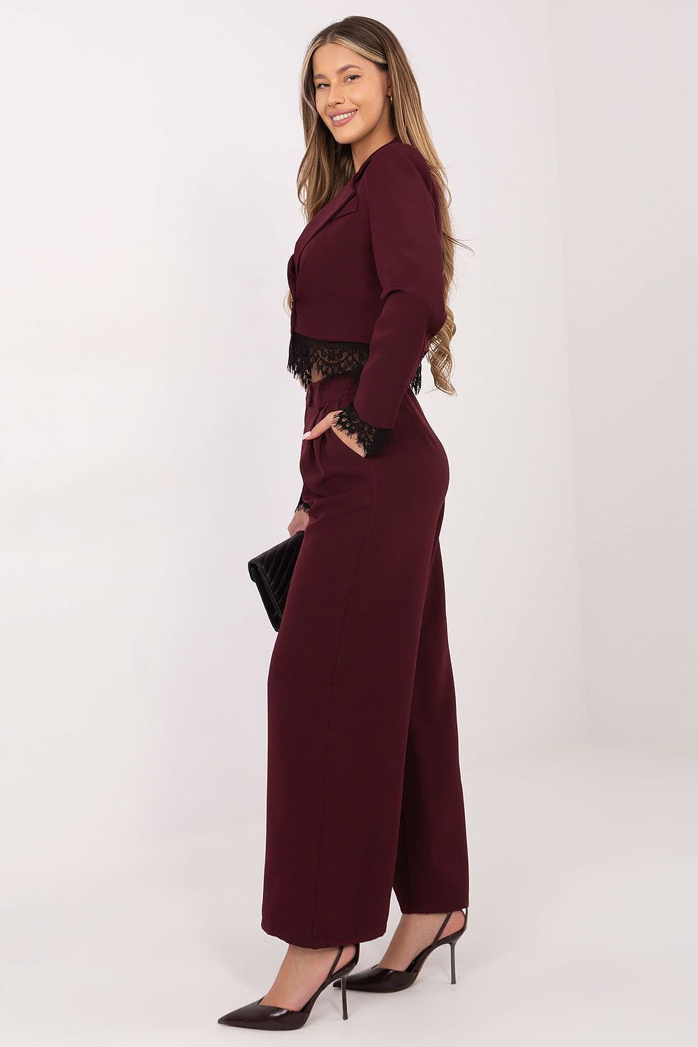 Burgundy high-waist trousers with wide legs and dark lace hem trim