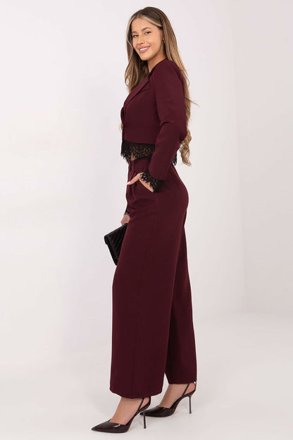 Burgundy high-waist trousers with wide legs and dark lace hem trim