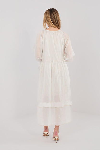 Cream long-sleeve daydress, back view, tiered skirt and belted waist