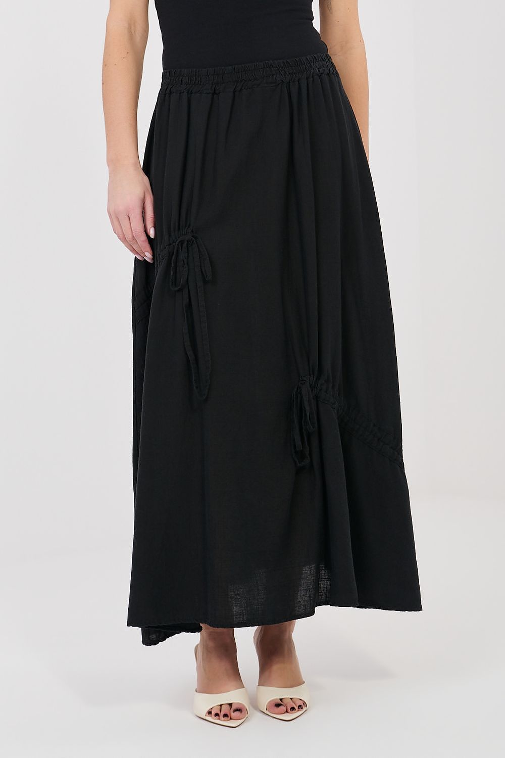 Black long skirt with elastic waist, side-tie detailing, and lace trim hem