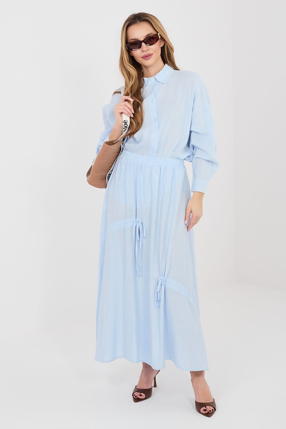 Light blue long skirt with elastic waist and side tassel ties, midi length