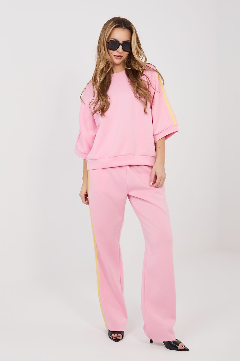 Pink matching set: short-sleeve top and wide-leg pants with gold trim