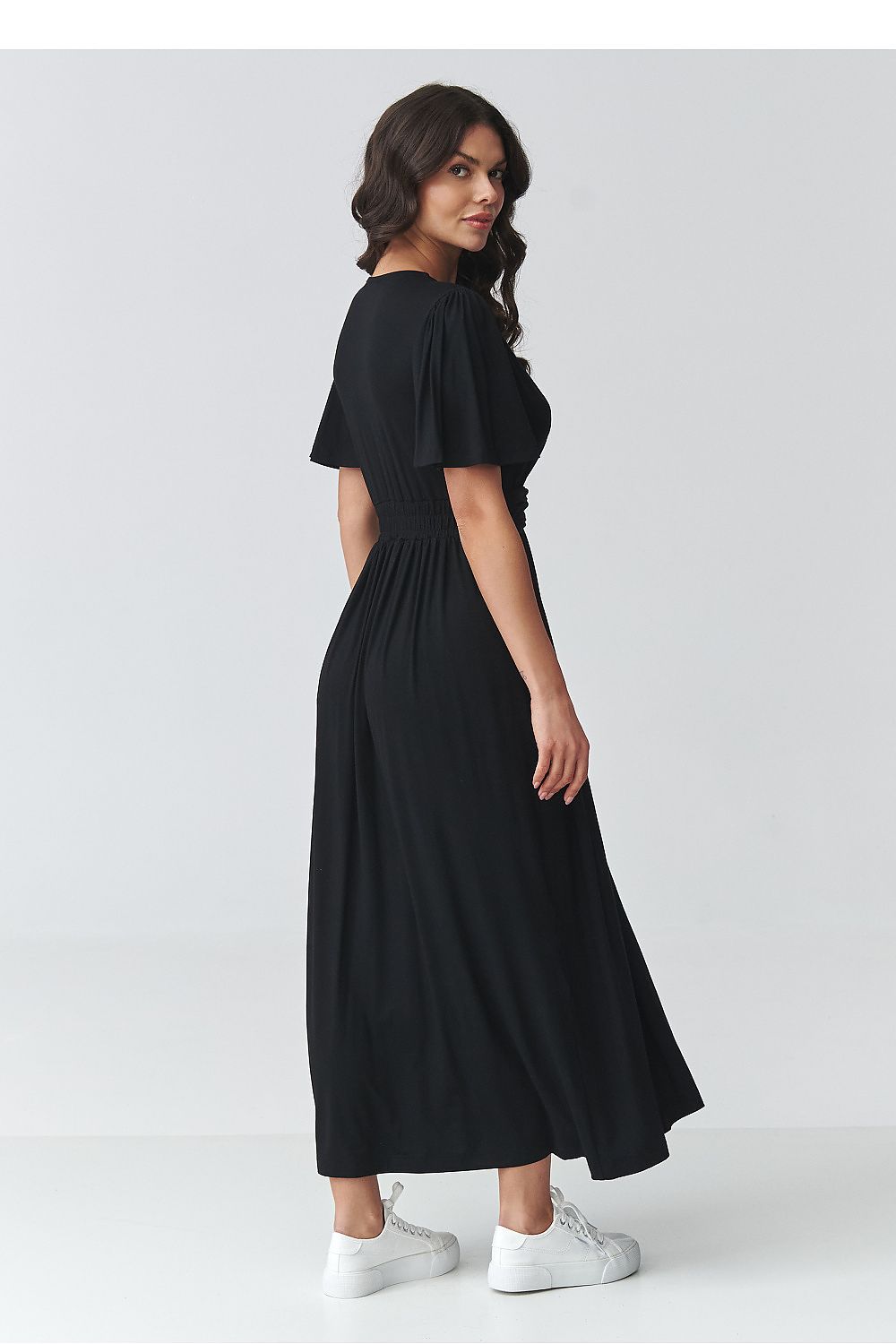 Black daydress back view with short flutter sleeves and gathered waist, long skirt
