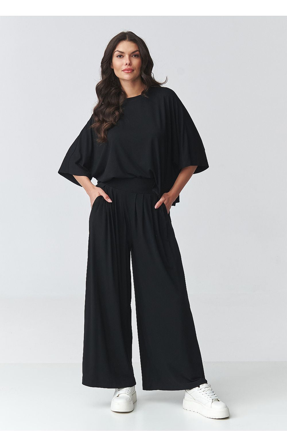 Black two-piece outfit set with loose batwing top and relaxed wide-leg pants
