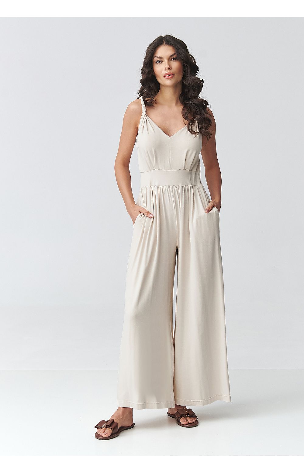 Light beige sleeveless V-neck wide-leg jumpsuit with gathered waist, full length