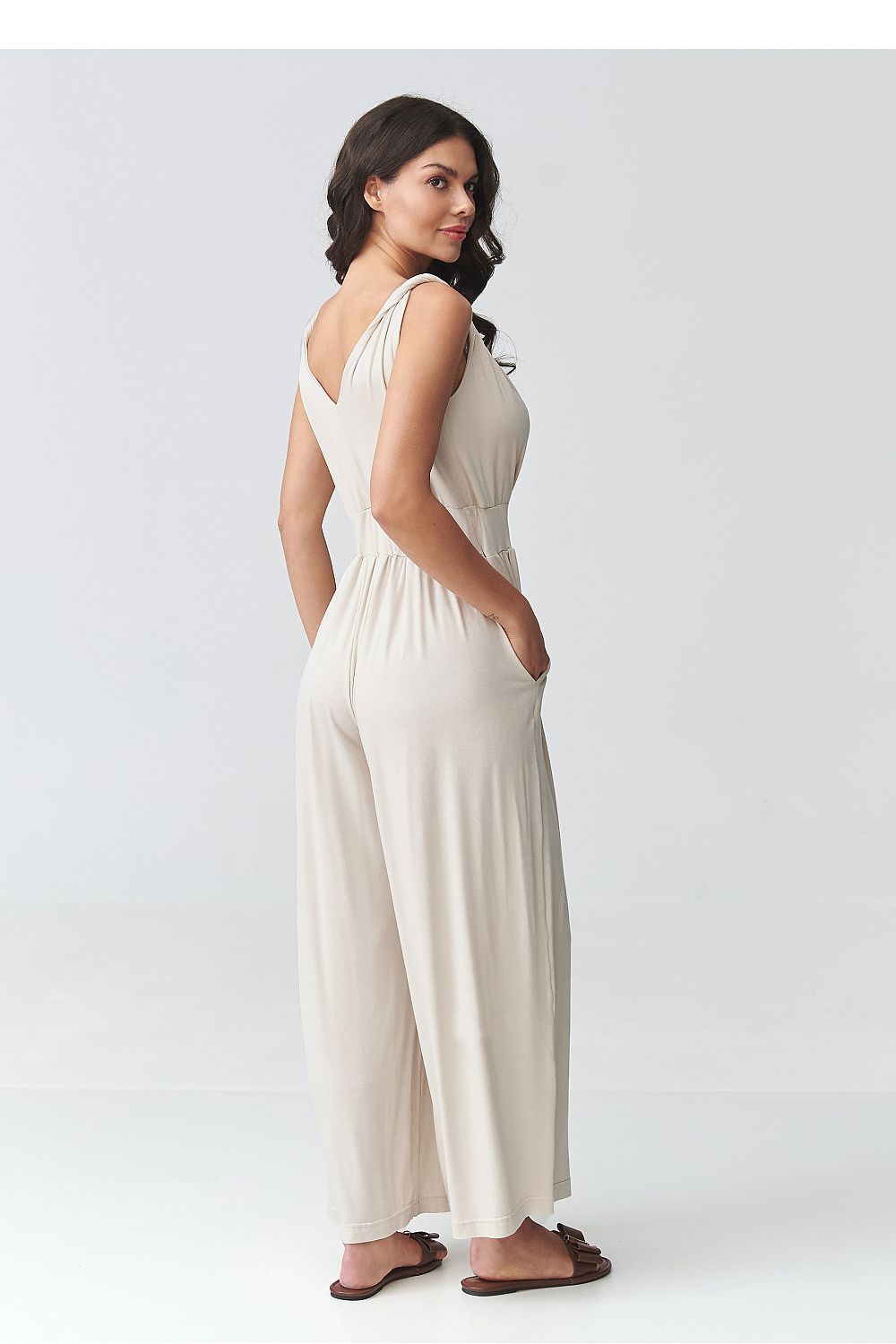 Light beige sleeveless V-neck wide-leg jumpsuit with gathered waist, side view