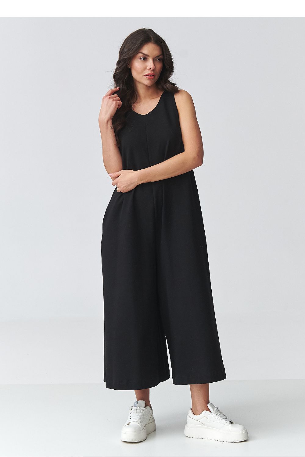 Black sleeveless wide-leg jumpsuit with scoop neckline and flowing wide pant legs