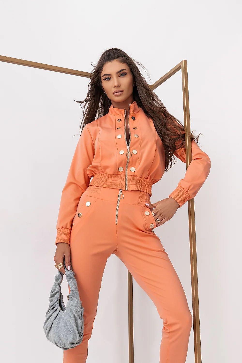 Orange two-piece lounge set with cropped button jacket and matching jogger pants