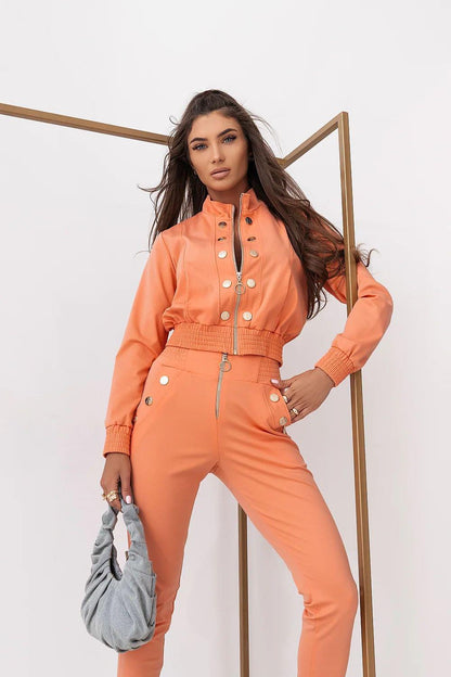 Orange two-piece lounge set with cropped button jacket and matching jogger pants