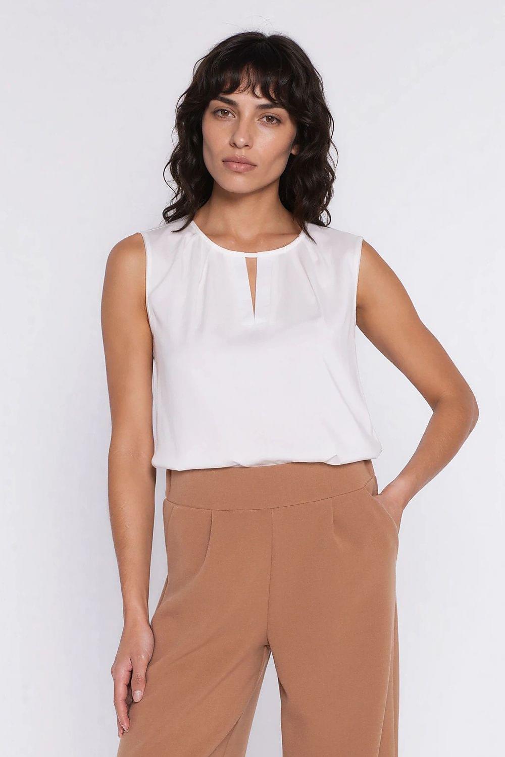 Sleeveless white blouse with keyhole slit at round neckline and loose drape