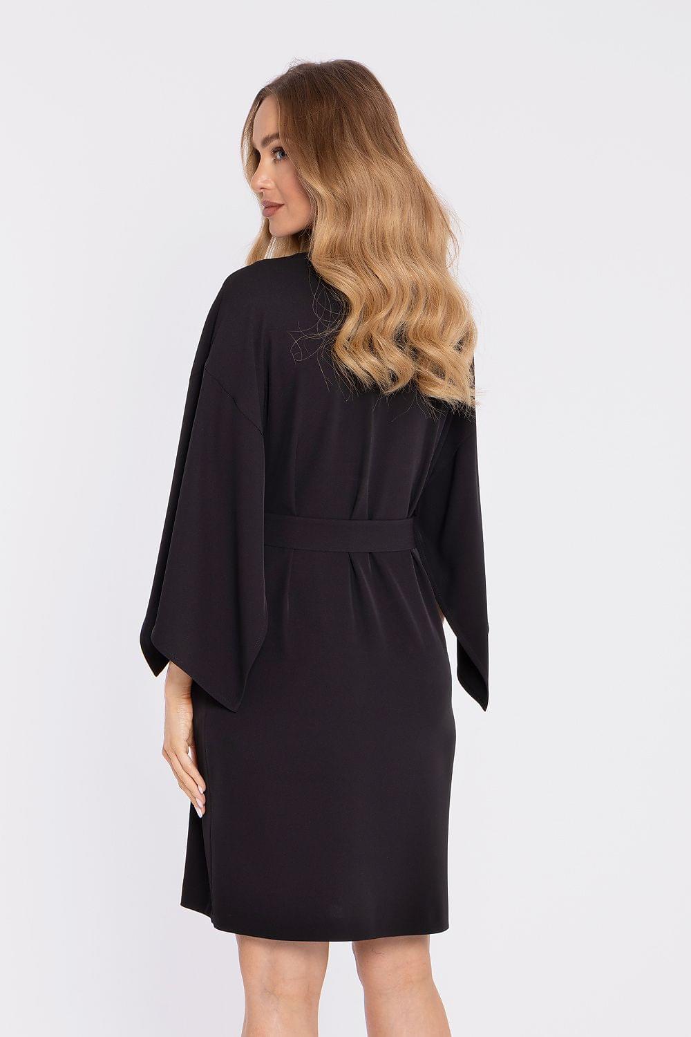 Black cocktail dress with tie waist and draped three-quarter sleeves, back view