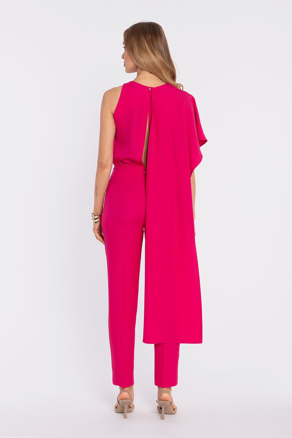 Fuchsia sleeveless back view jumpsuit with long draped overlay and tapered pants
