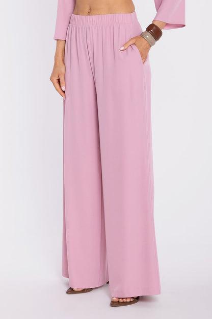 Women’s wide-leg trousers in soft pink, elastic waist and flowy drape.