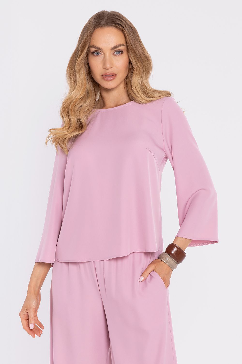 Pink blouse with round neckline and 3/4 flared sleeves; matching wide-leg pants.