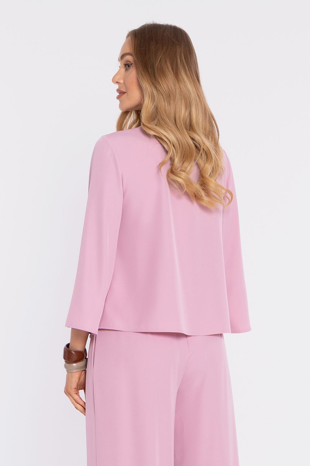Pink blouse from side view with flared sleeves and round neckline; matching pants.